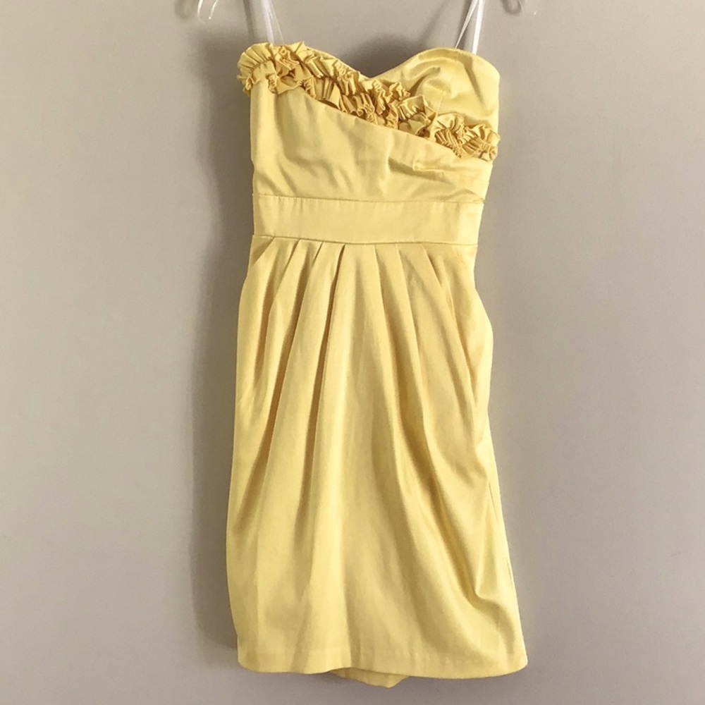 Yellow strapless dress.